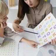 woman-doing-speech-therapy-with-little-boy-her-clinic